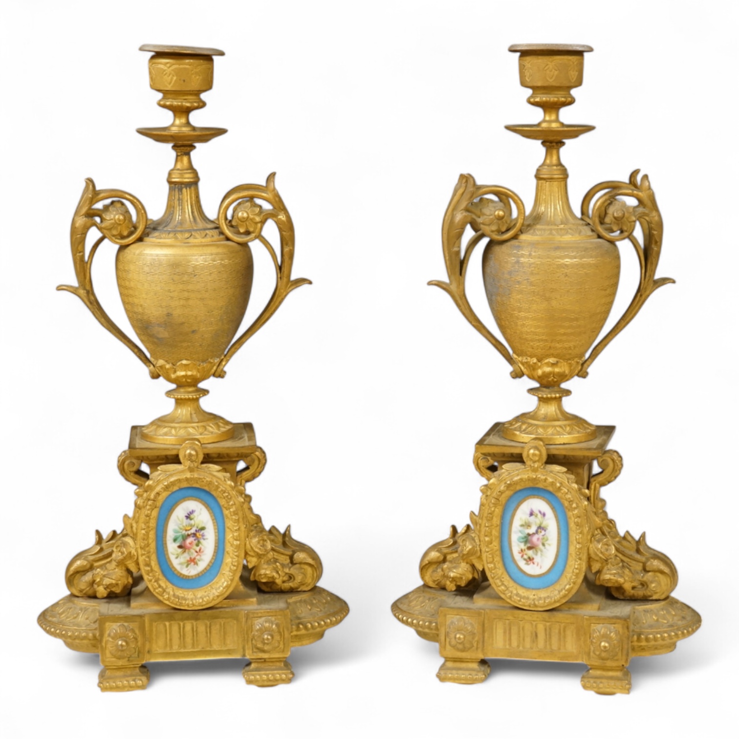 A pair of 19th century gilt metal candlesticks with inset porcelain panels, 32cm high